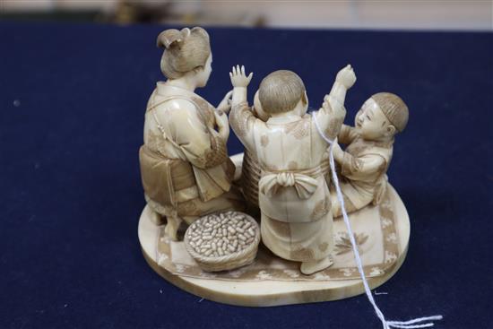 A good Japanese ivory okimono of a lady and children playing, Meiji period, H.9.5cm, W.12.2cm